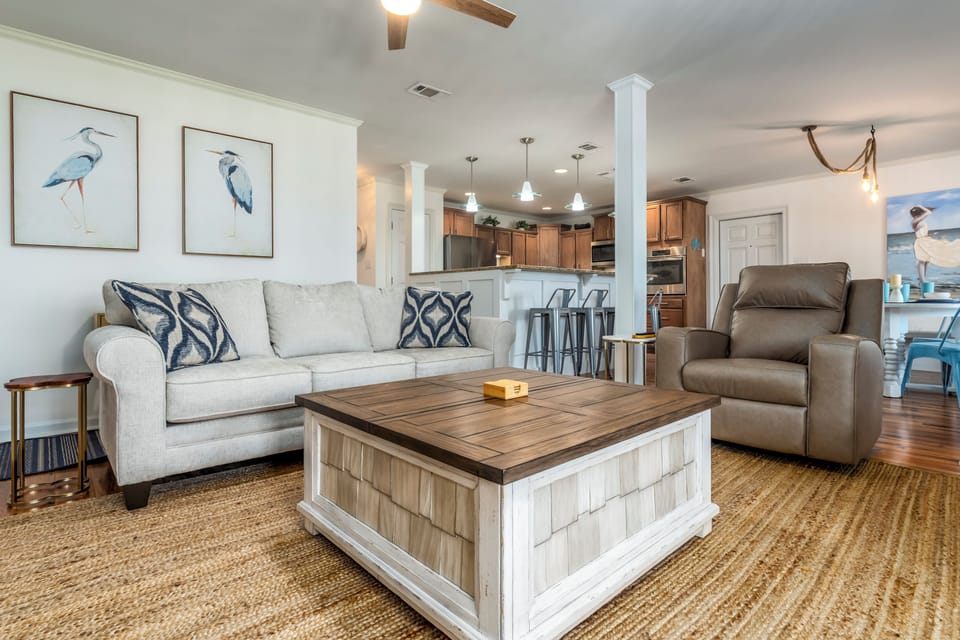 Unwind in your coastal-inspired living room where soft textures meet warm wood tones, creating the perfect retreat for relaxation.