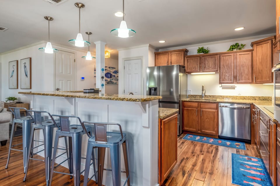 Your modern kitchen awaits with granite countertops, stainless steel appliances, and a breakfast bar perfect for morning coffee.