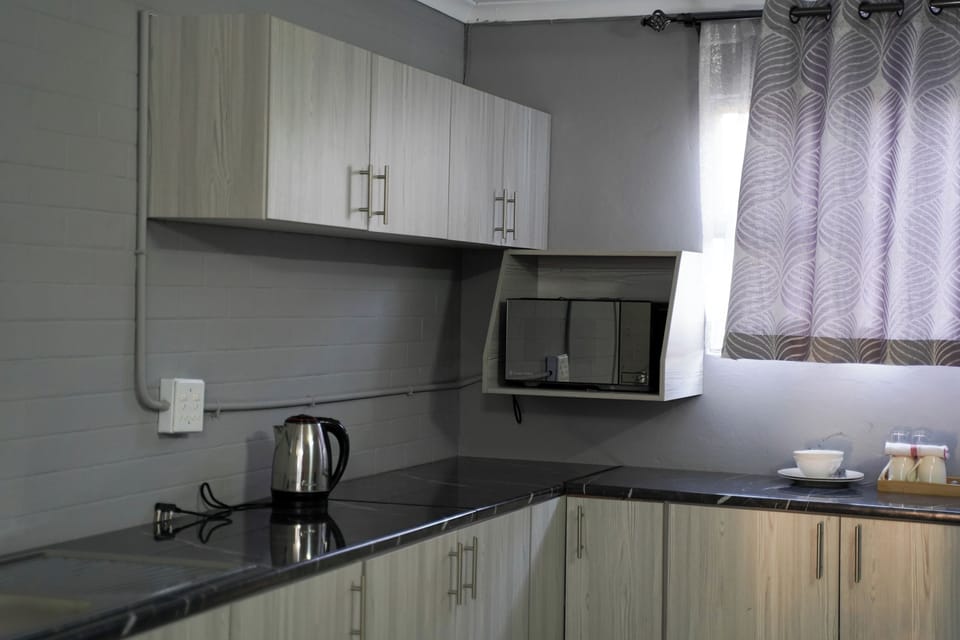 Deluxe Apartment, Garden View | Private kitchen | Fridge, cookware/dishes/utensils