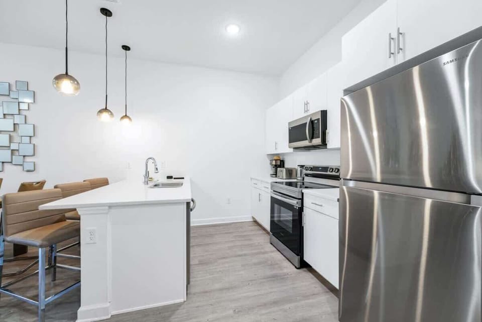 The kitchen boasted gleaming stainless steel appliances, ample counter space, and a charming breakfast nook bathed in the morning sunlight.
