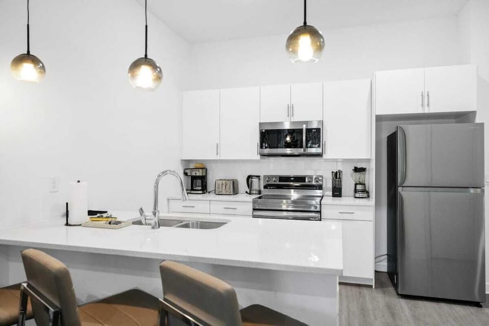 The kitchen boasted gleaming stainless steel appliances, ample counter space, and a charming breakfast nook bathed in the morning sunlight.The kitchen boasted gleaming stainless steel appliances, ample counter space, and a charming breakfast nook bat