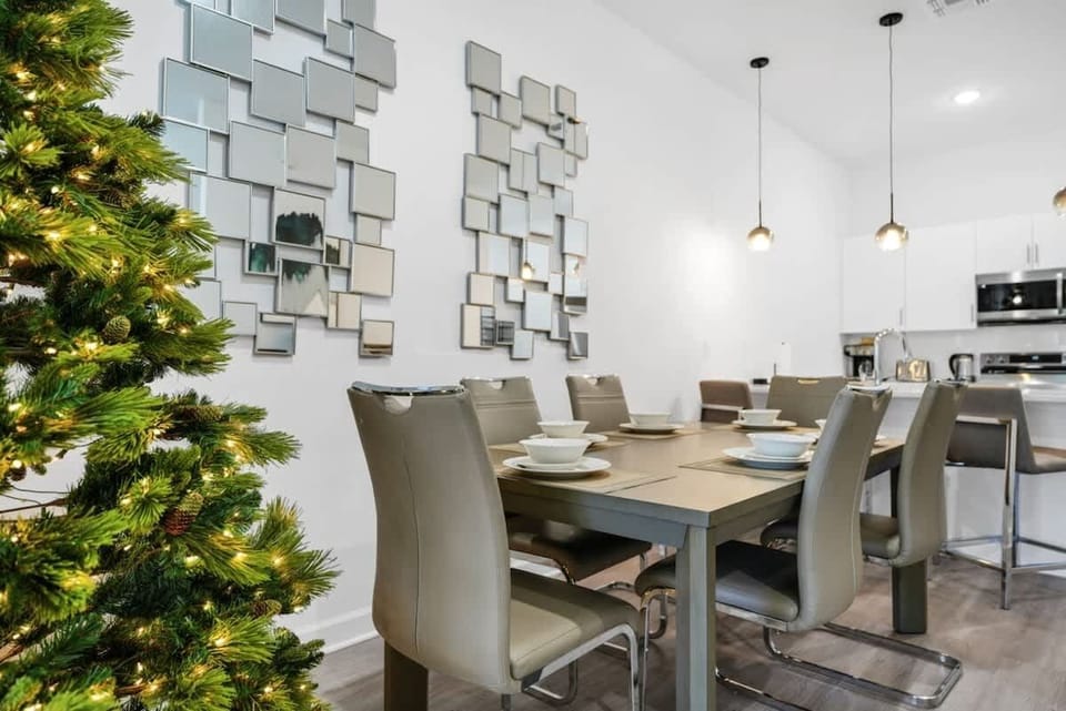 The dining area featured a rustic wooden table surrounded by comfortable chairs, perfect for enjoying meals with family and friends against a backdrop of softly glowing candles.