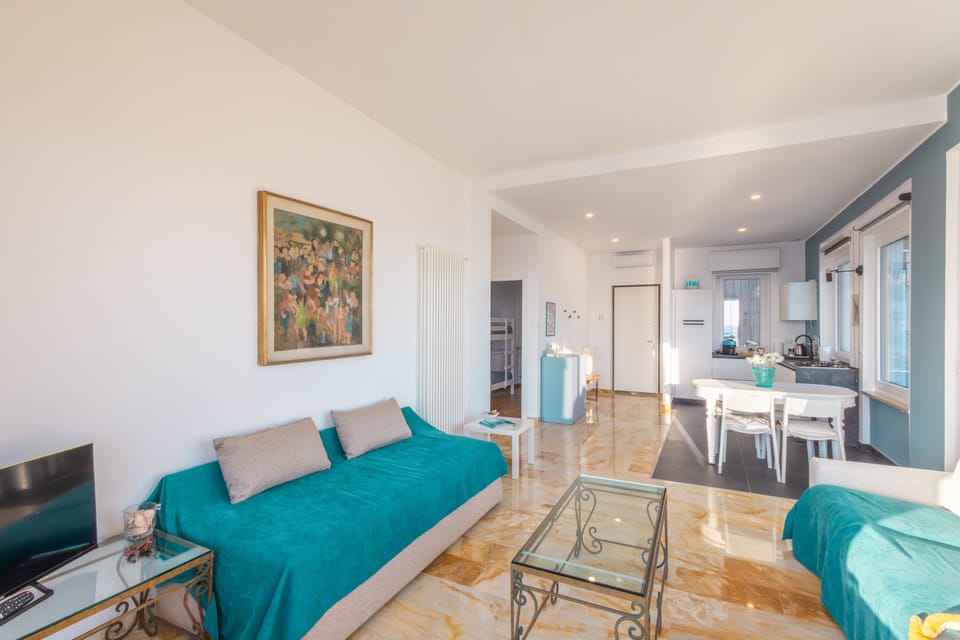 Apartment, Sea View | Living area | 35-inch TV with digital channels