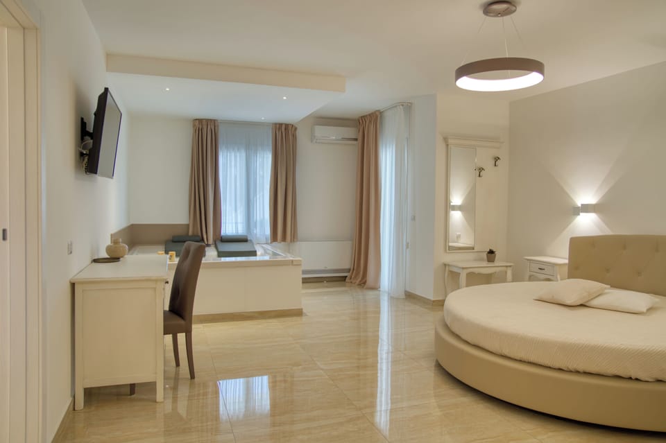 Suite, Garden View | Premium bedding, down comforters, minibar, in-room safe