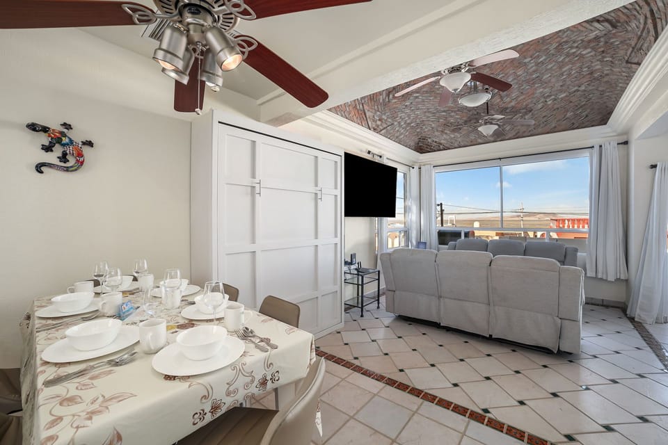 Open-concept dining and living area with Murphy bed concealed ideal for relaxing or entertaining with ocean views.