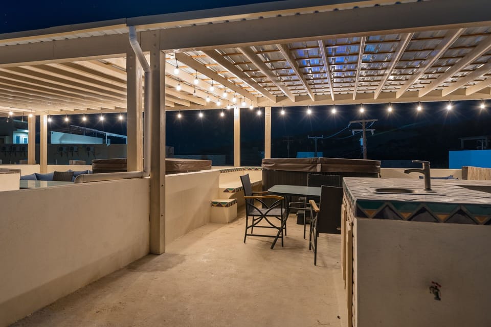 Enjoy outdoor dining, panoramic views, and your own private bar area under the rooftop palapa.