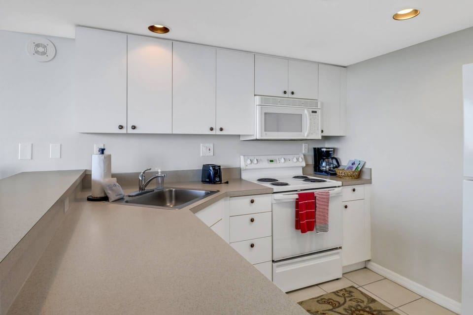 The kitchen comes equipped with stove, microwave, fridge/freezer, compact dishwasher, cookware, dinnerware and basic kitchen tools.