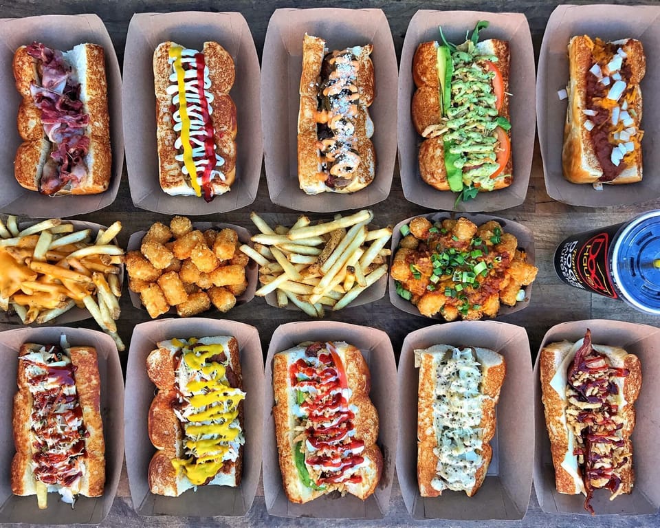 Grab a burger and a local brew at Dog Haus Biergarten, a laid-back spot known for creative hot dogs, handcrafted burgers, and a fun patio atmosphere.