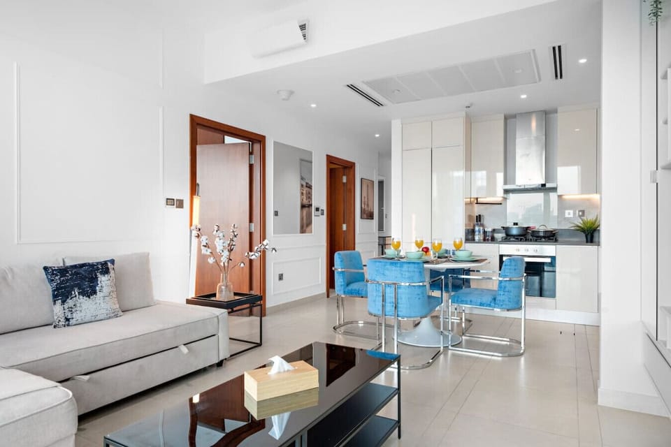 Living Room: Sleek space with modern decor, vibrant dining, and light-filled ambiance! Enjoy your stay!
