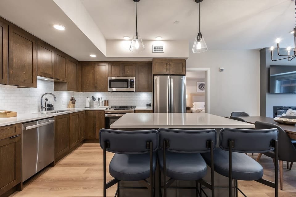 Kitchen features and island with a breakfast bar with seating for 3.