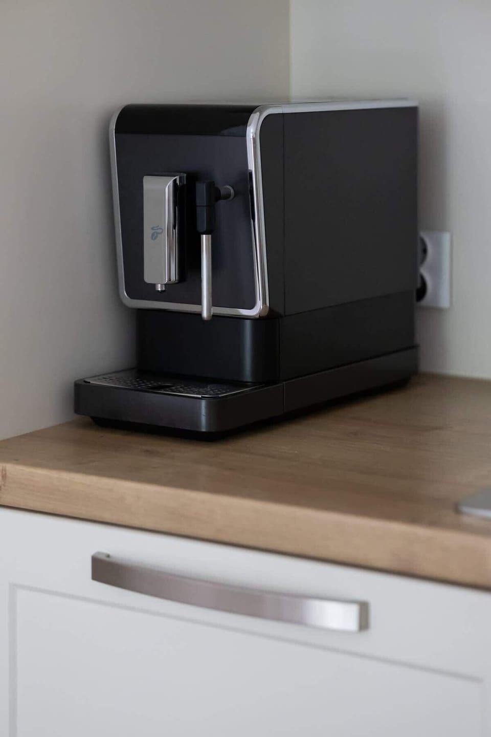 The sleek design of the kitchenette blending seamlessly with the living area.