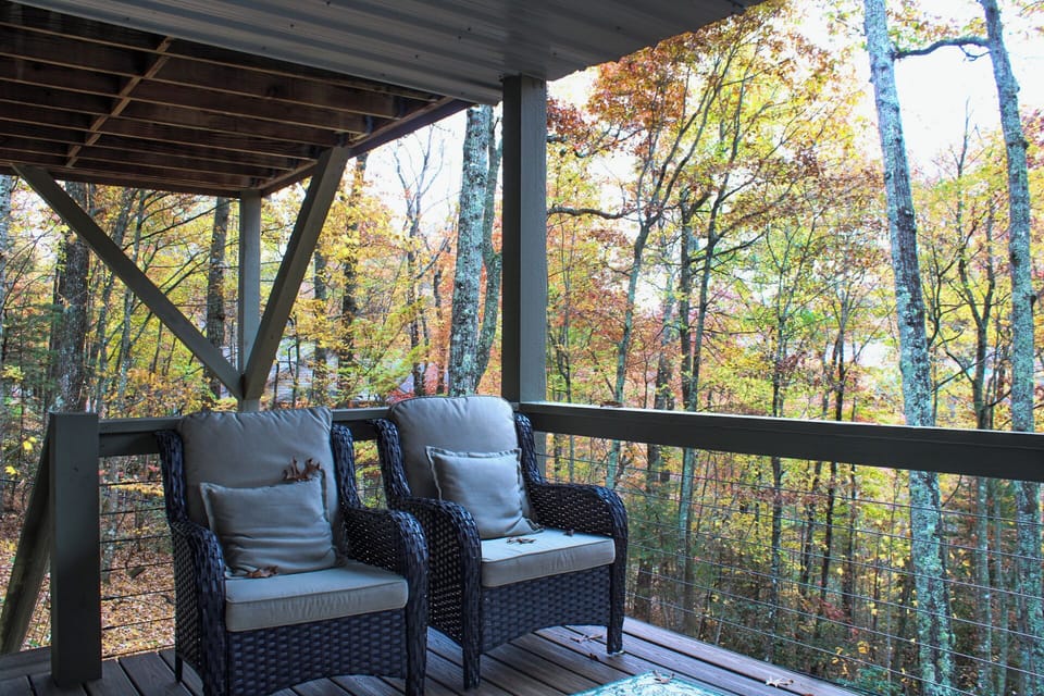 Chairs underneath balcony, near hot tub, downstairs. Stairs lead to fenced yard.