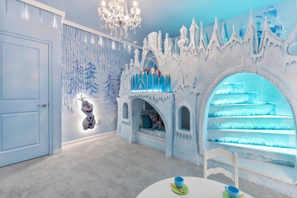 Enter a whimsical wonderland of shimmering icy blue tones. The playful ice castle features glowing staircases and enchanting decor, ensuring fun and adventure for young guests, while a charming chandelier adds an elegant touch.