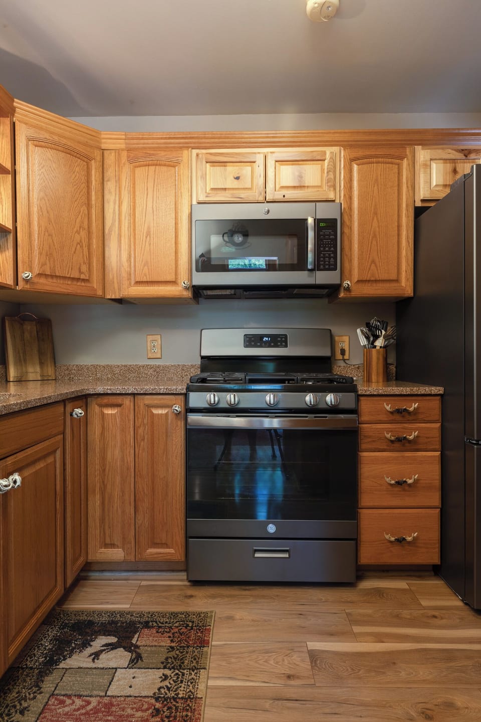 Plenty of cabinets surrounding the gas range, microwave and refrigerator. 