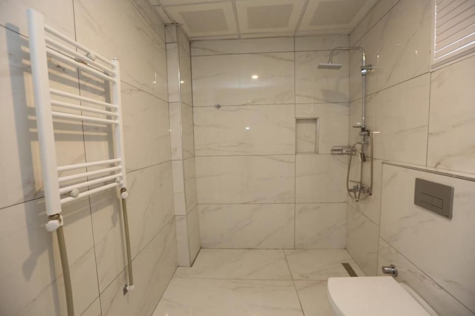 Shower, hair dryer, slippers, towels
