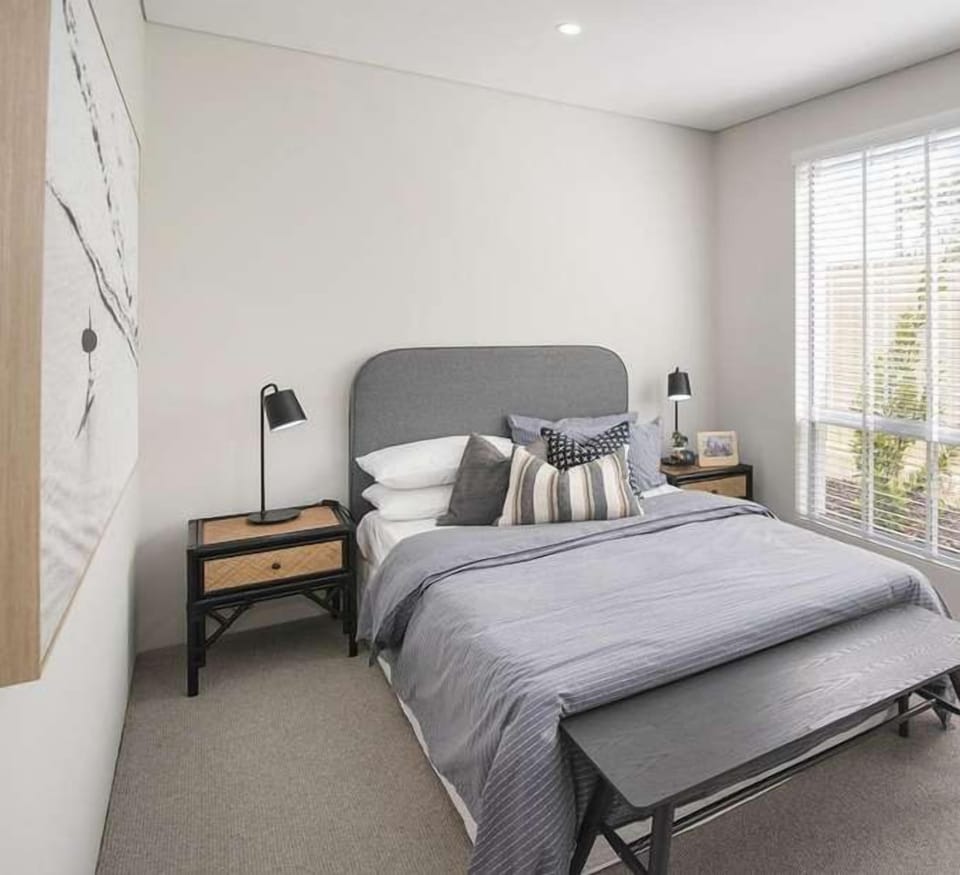 Rest comfortably in the double bed, complemented by crisp linen, layered cushions and understated styling in calming grey tones.