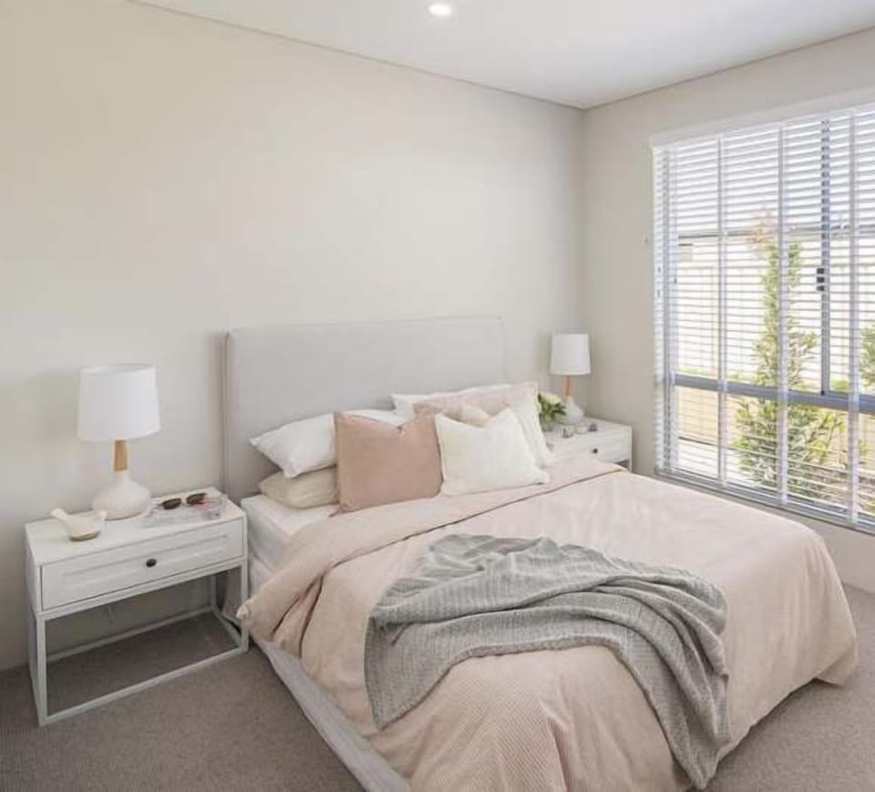Enjoy a peaceful retreat in this light-filled bedroom, featuring a comfortable double bed, soft blush bedding and soothing neutral décor.