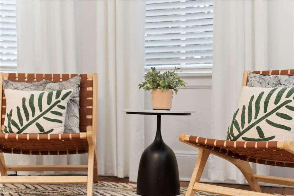 This charming seating area in the primary bedroom is perfect for sipping coffee, reading, or simply relaxing in style.