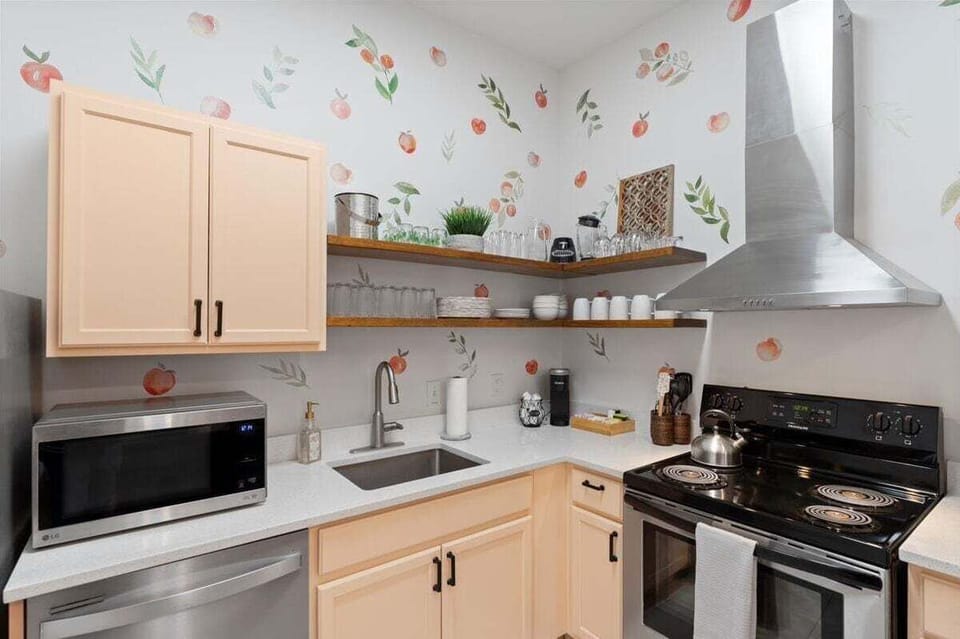Peach cabinets and charming peach-themed decor make this space as delightful as it is functional.