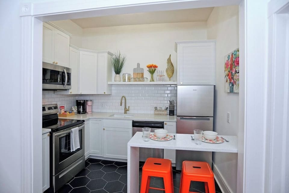 The bright and cheerful kitchen is packed with charm and everything you need for a cozy stay in the heart of Savannah