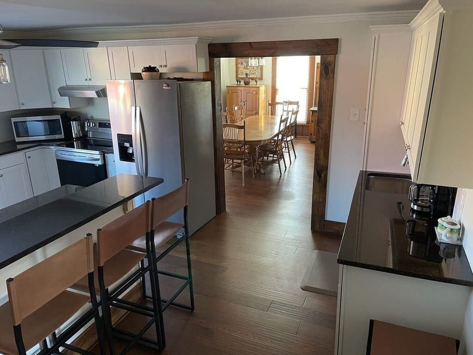 The newly renovated kitchen offers seating at the island and drink bar with sink