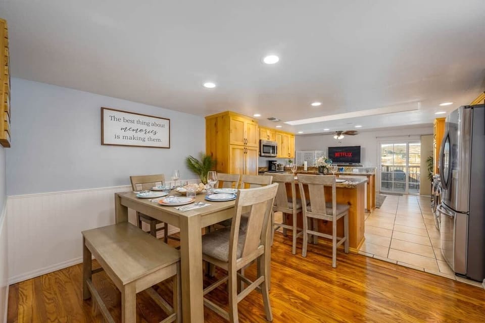 Spacious and welcoming dining area seamlessly connected to the kitchen, featuring comfortable seating for eight—perfect for family meals or entertaining guests.