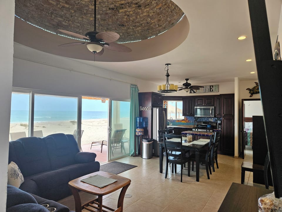 Oceanfront living dining & kitchen with Boveda ceiling.  Huge Smart TV