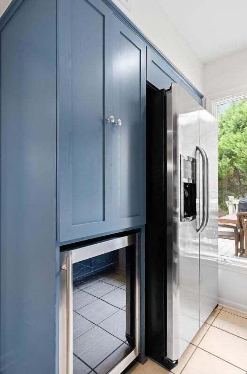 The kitchen has a beverage refrigerator as well as a full refrigerator