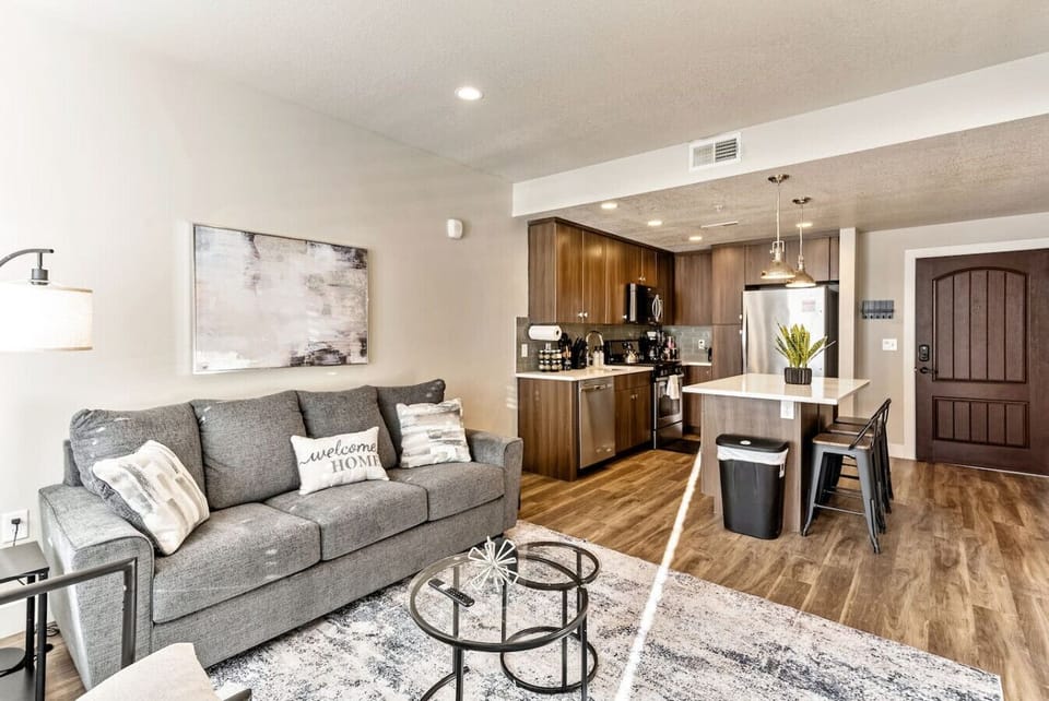 Open living area flowing into kitchen, perfect for gathering & unwinding