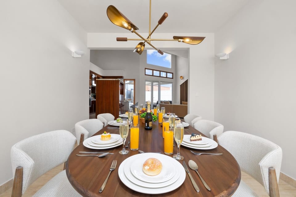 Step into this inviting dining area, where a beautifully crafted table, plush chairs, and warm lighting come together to create a cozy retreat, ideal for sharing meals, making memories, and enjoying quality time with family and friends.