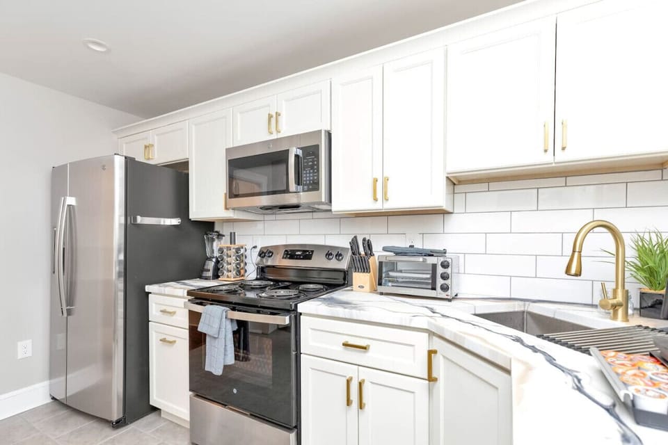 Fully Equipped Kitchen: Features a dual coffee maker, stove, dishwasher, microwave, and all the essentials for your culinary adventures.