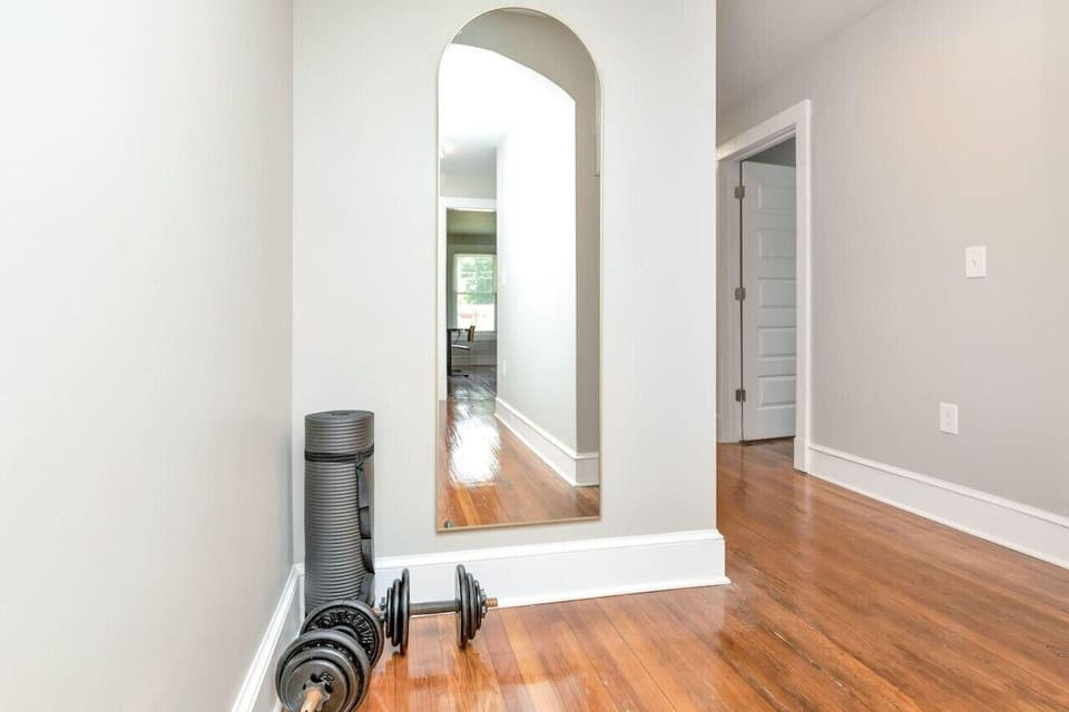 Workout Area: Stay fit with a yoga mat, free weights, and a full-length mirror.