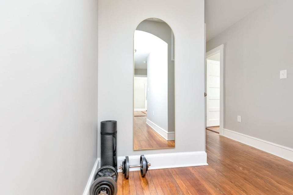 =“Get Moving”  Keep your fitness on track with a yoga mat, free weights, and full-length mirror—your personal workout zone.
