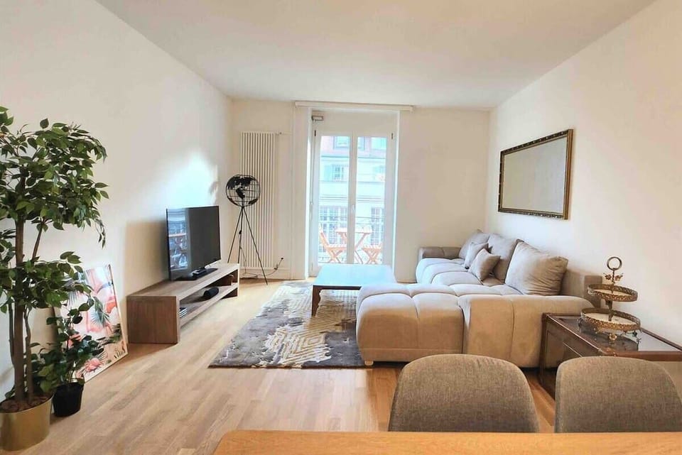 Spacious and bright living room with balcony. 

Sofa can be converted to a comfortable sofa bed.