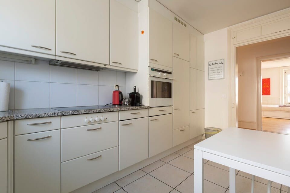 Bright and spacious kitchen with a big window and ample storage space -  fully equipped with dishwasher, fridge, microwave, oven, toaster, Nespresso coffee machine etc. 

A cozy table for casual dining or as additional tabletop space.