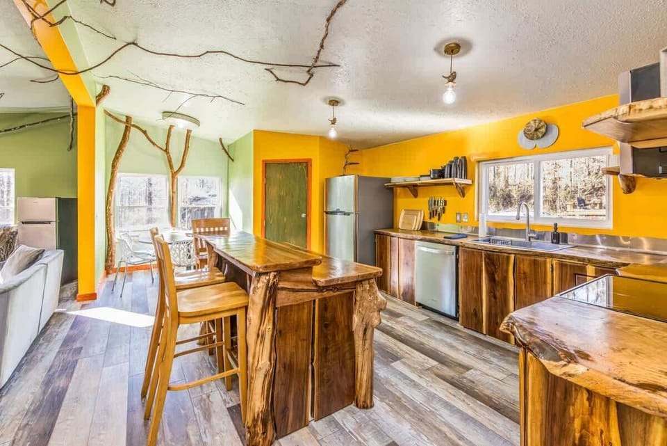 A custom and fully stocked black walnut kitchen is perfect for groups, sustainably made by two artists from a local fallen tree.