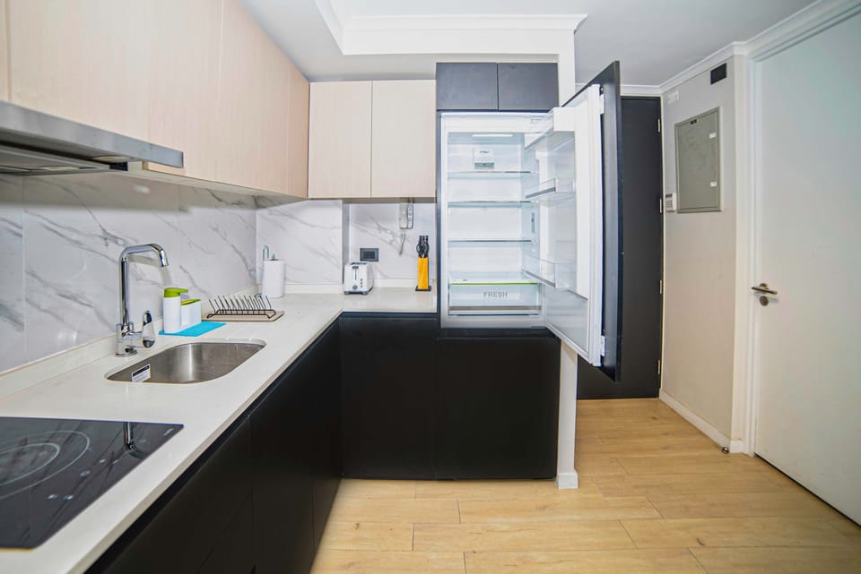 Sleek, modern kitchen with ample storage and high-end appliances, perfect for preparing meals during your stay.