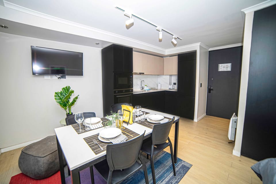 Modern dining and kitchen area with sleek design and cozy ambiance, perfect for a comfortable stay.