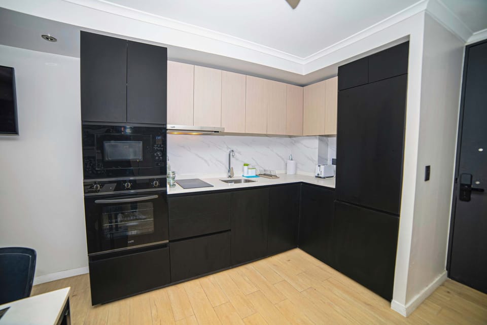 Sleek and modern kitchen with all essentials for a comfortable stay in the heart of the city.