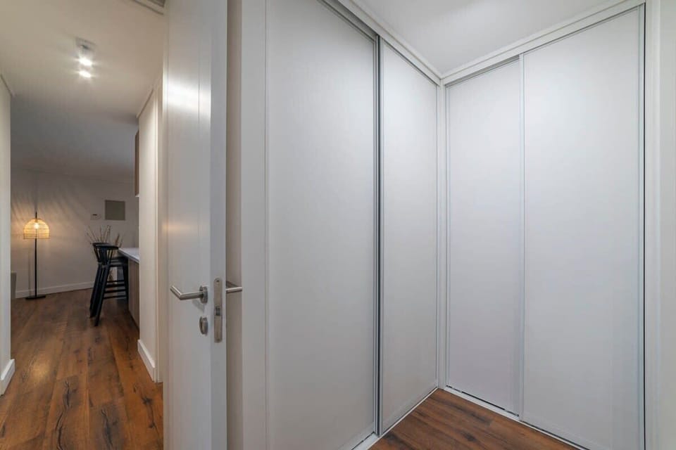Bright and spacious hallway with ample storage, leading to a cozy living area with modern amenities.