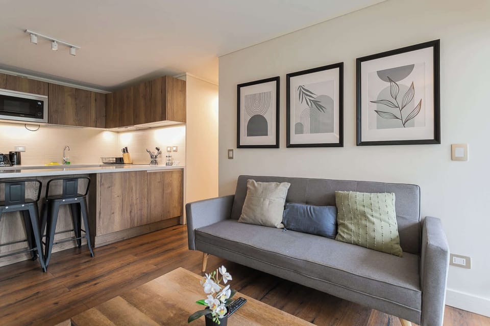 Modern studio with stylish decor, cozy seating, and a fully equipped kitchen, perfect for a relaxing stay in Chile.