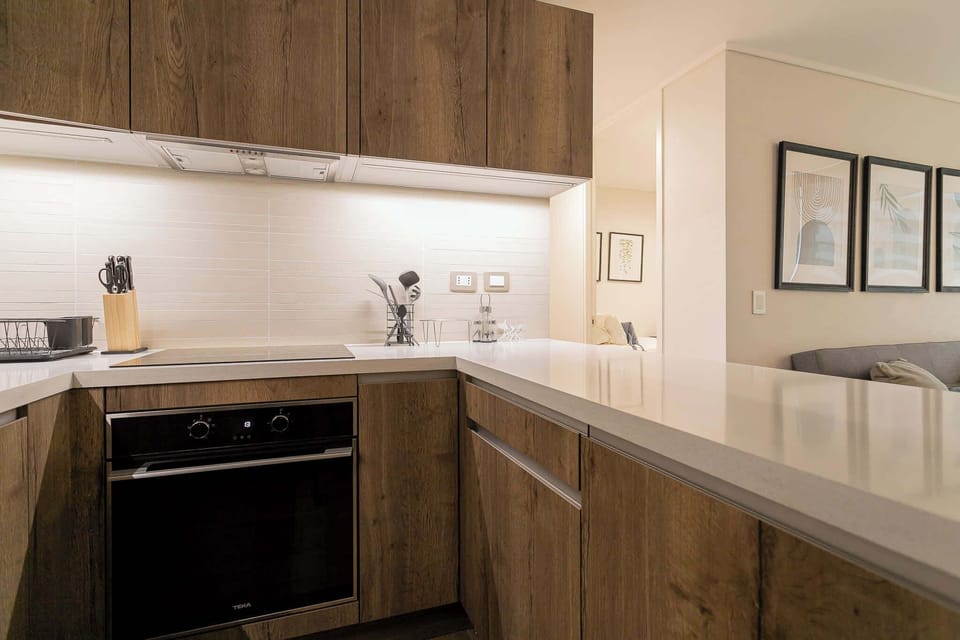 Sleek and modern kitchen with top-notch amenities, perfect for culinary enthusiasts seeking a stylish cooking space.