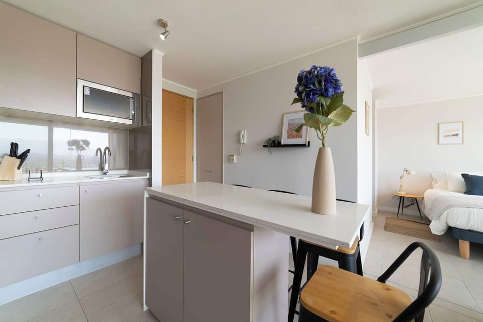 Chic and modern kitchen with natural light and stylish decor, perfect for a cozy meal.