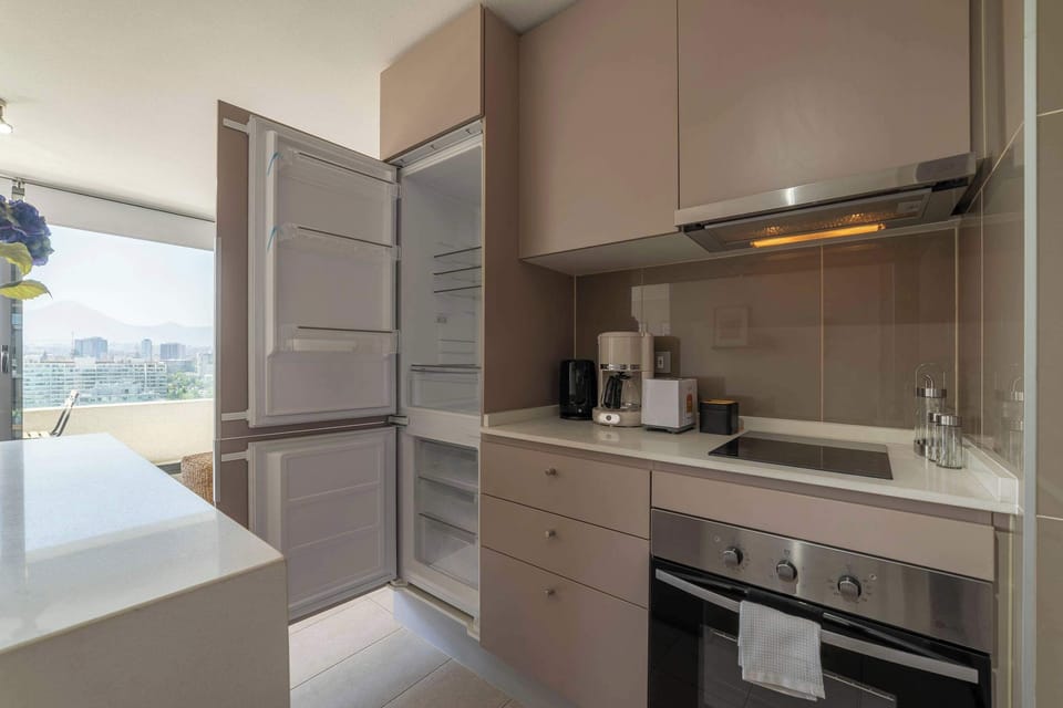 Sleek kitchen with modern appliances and stunning city views, perfect for culinary enthusiasts.