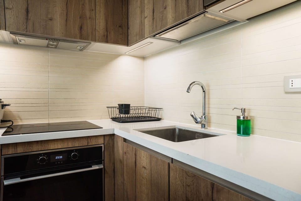 Modern kitchen with sleek appliances and ample workspace, ideal for culinary enthusiasts.