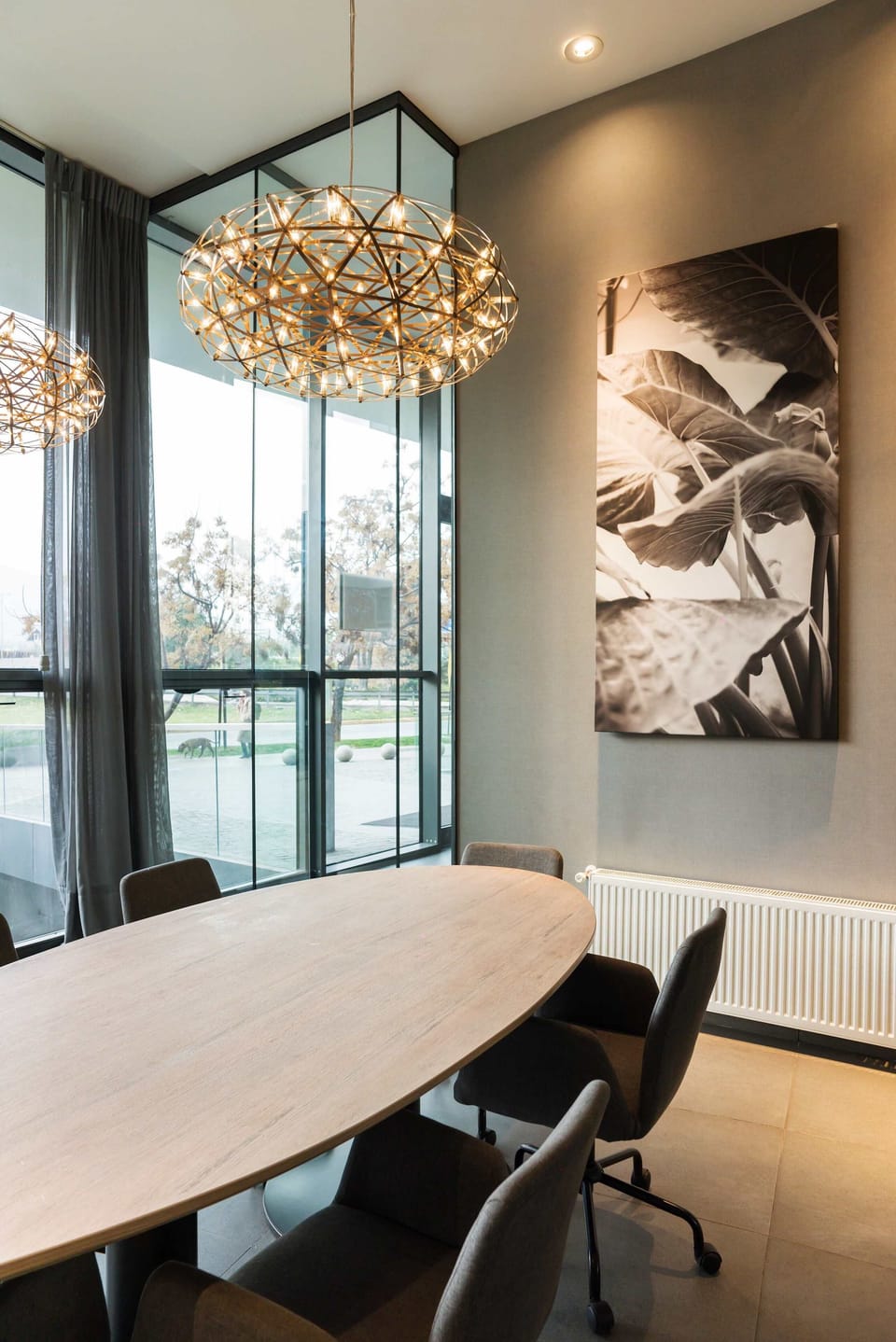 Elegant dining area with modern lighting and artistic decor, perfect for gatherings.