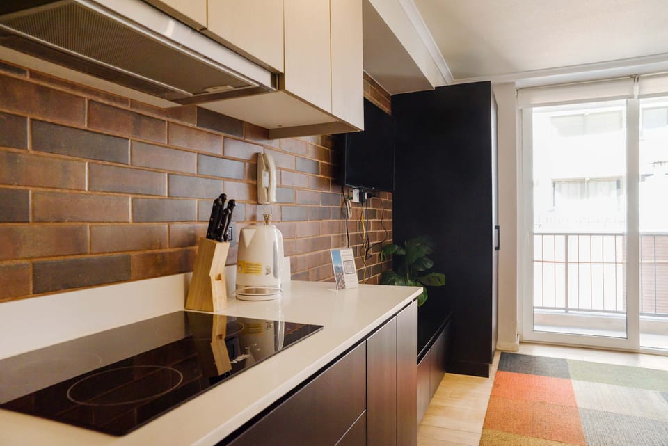 Modern kitchen with sleek design and natural light, perfect for cooking a delightful meal.