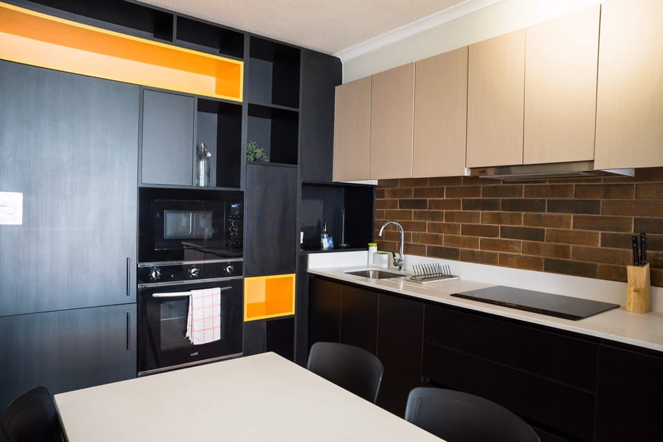 Sleek and modern kitchen with all essentials for a cozy meal in your stylish studio.