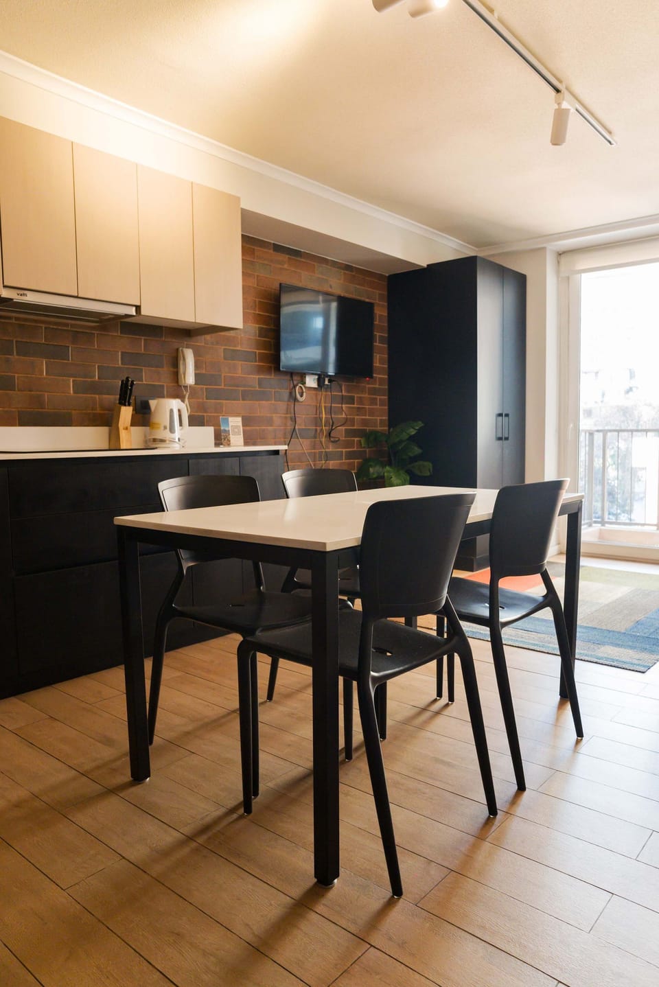 Cozy dining area with modern amenities and natural light, perfect for intimate meals in your Chilean apartment studio.