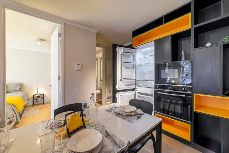 Stylish and modern kitchen with vibrant accents, perfect for a cozy meal. Enjoy the convenience of a fully equipped space.